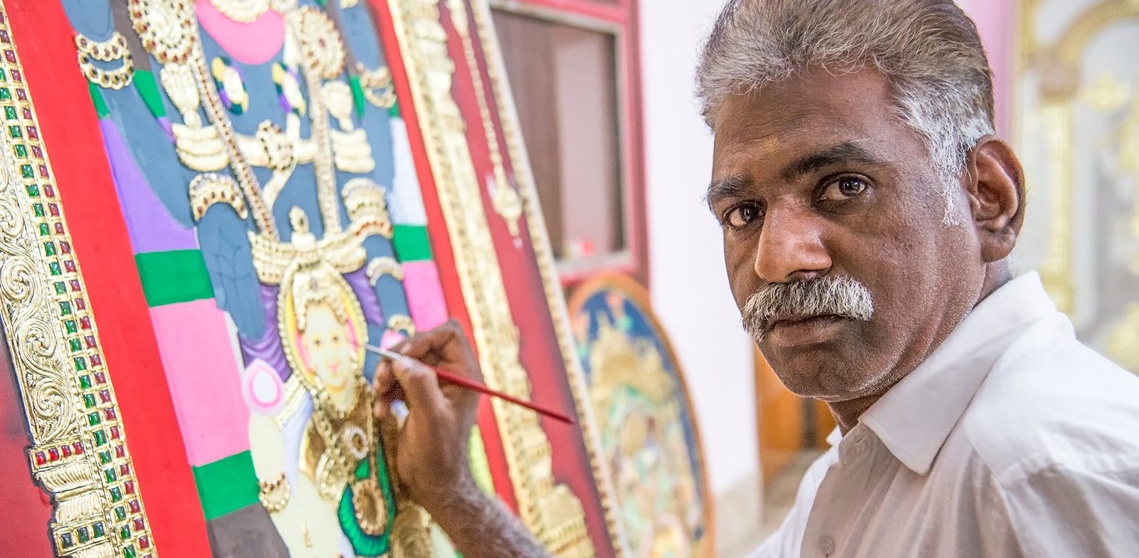 Craft: (Clockwise from above) Marimuthu demonstrates the timeless art of Thanjavur painting; after placement, the gold foil is carefully cut to reveal the various jewels beneath; a rotund Krishna typical of Thanjavur depictions; Goddess Annapurni, Deity of nourishment and abundance; an artist at work on what appears to be a painting of Goddess Lakshmi seated on a lotus flower