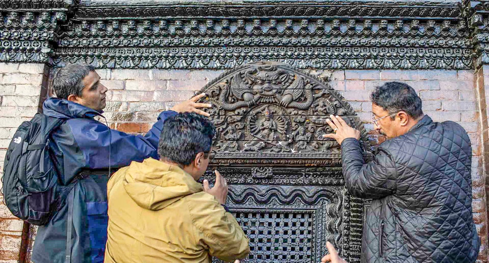 Priceless sacred artifacts: (above) A wooden tympanum, stolen from the Kumari House at Kathmandu’s Durbar Square around 2000, was found at the Barakat Gallery in the UK, repatriated and formally reinstalled in 2025 with much fanfare. (right) five out of twelve gilded, copper-bronze inlaid Deities of a frieze at the Taleju Bhavani Temple in Patan were stolen and later turned up at the Bonhams Auction in Paris. They have not yet been successfully repatriated, but replicas were created in the meantime. (below) the Chaturmurti Vishnu from Maligaon, stolen in the 1980s, was later discovered buried in the bank of Dhobikhola, a tributary of the Bagmati River, and reinstalled in its original location.